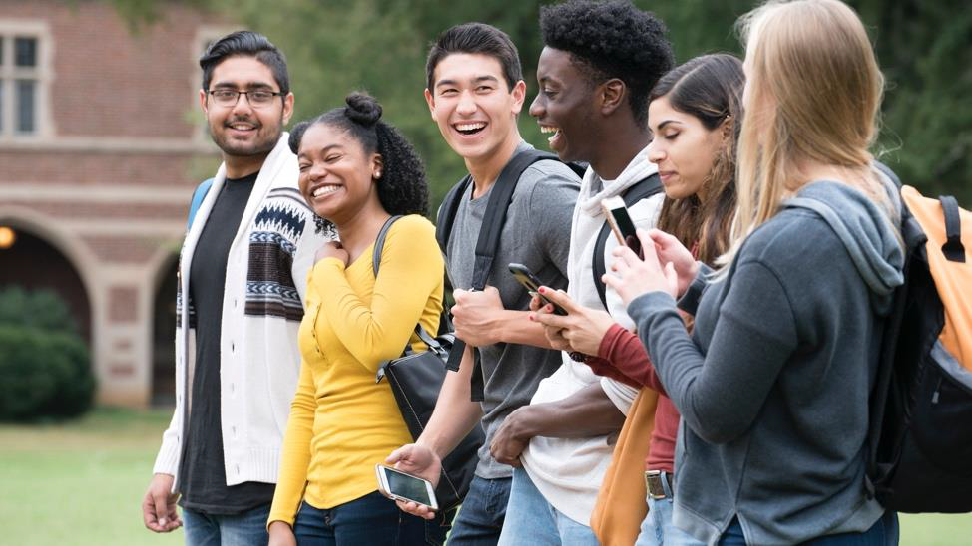 College students walking through a modern campus, transitioning from education to professional internship opportunities.